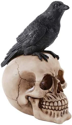Hand-painted ceramic figurine of a bird perched on a skull