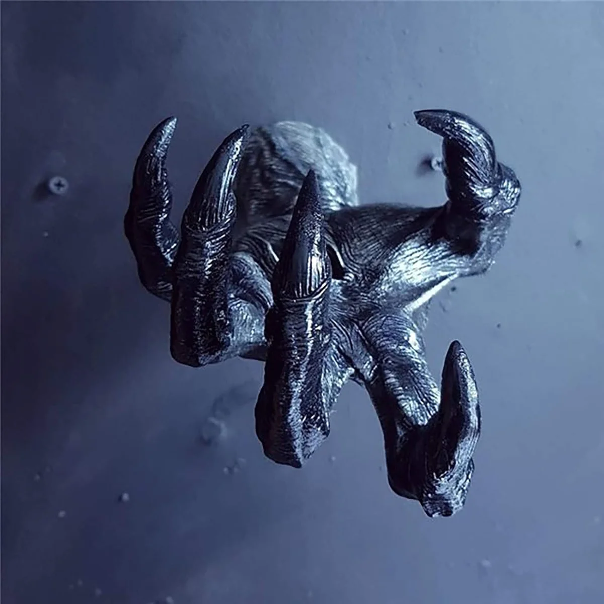 Black resin demon hand wall sculpture with palm facing outward