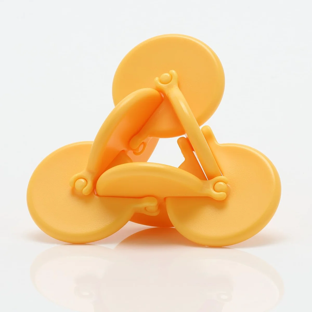 Yellow perpetually spinning fidget toy with rotating geometric mechanism
