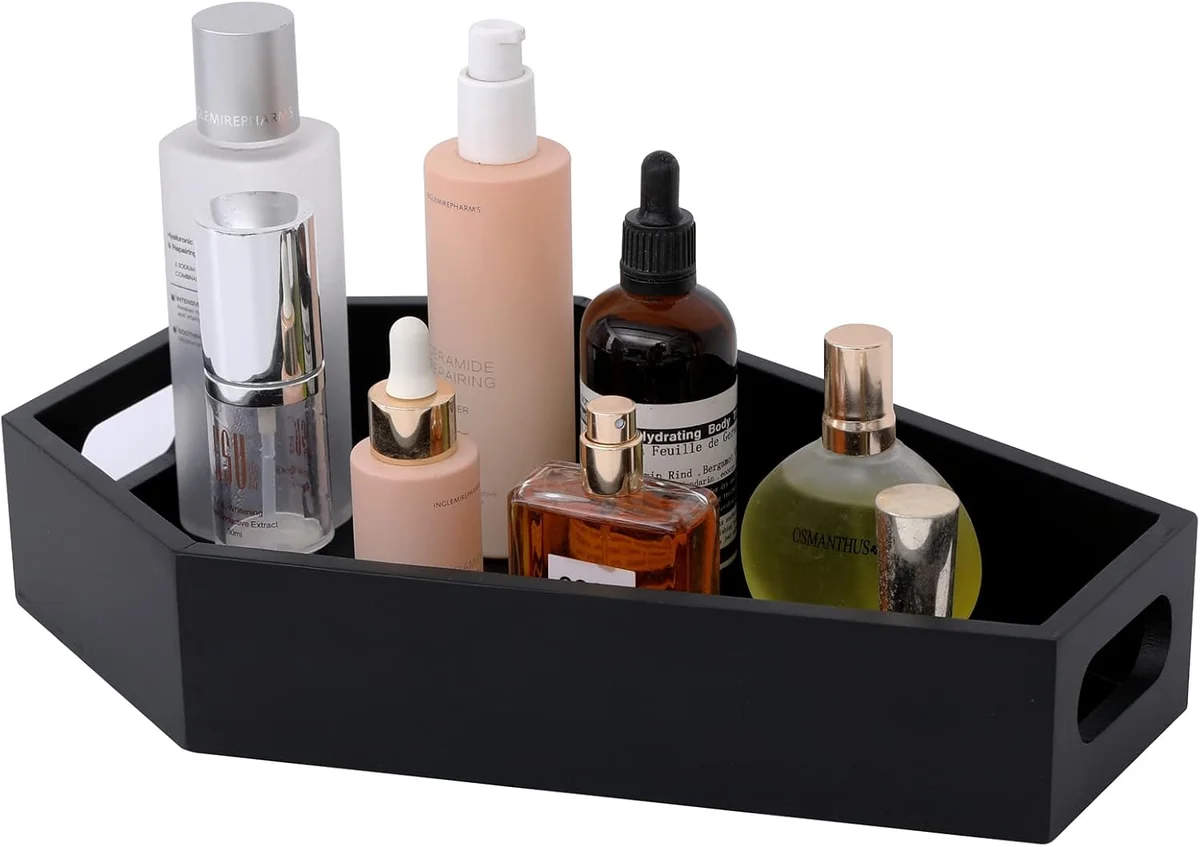 Matte black coffin-shaped wooden makeup organizer with a hexagonal footprint and multiple internal compartments, sized for a vanity or bathroom counter to hold lipsticks, brushes and small cosmetics