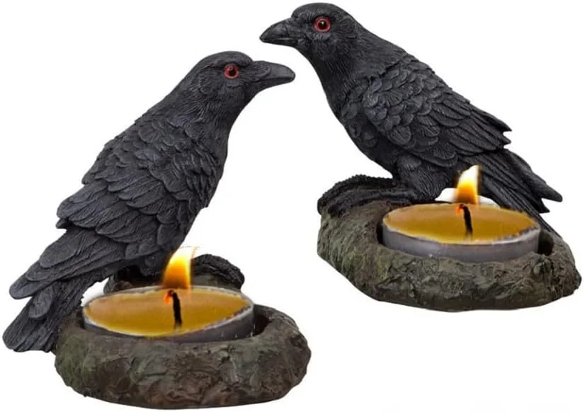 Pair of raven-shaped tea light holders in black metal finish