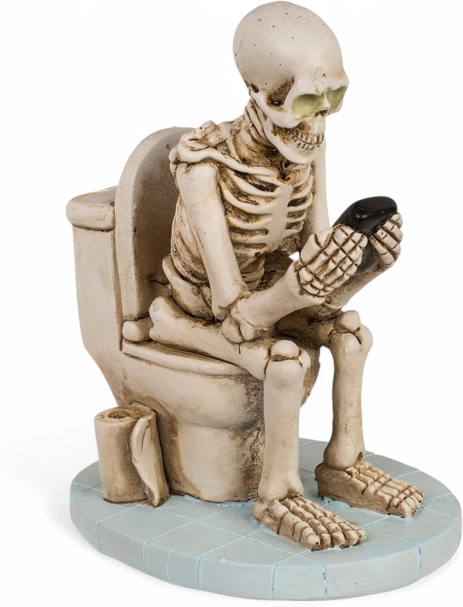 Polyresin skeleton figurine sitting on a toilet