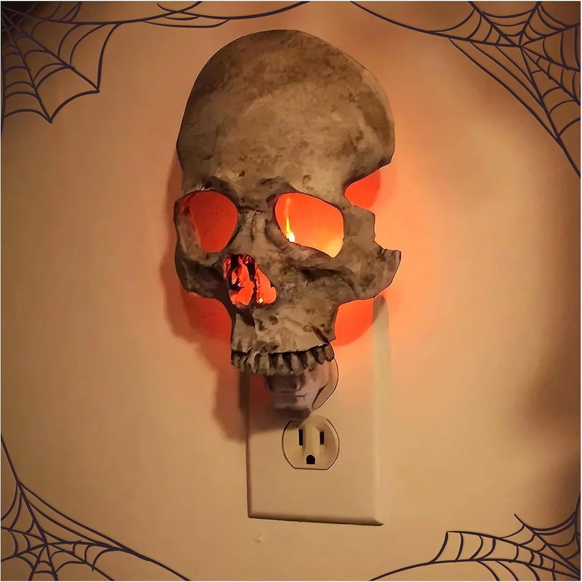 Skull-shaped night light with grey finish and warm LED glow