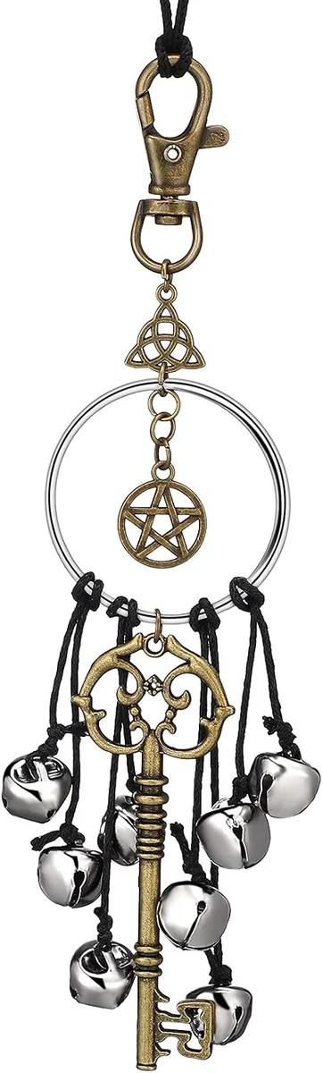 Antique brass and copper witch bells with wiccan charms and magic key pendants designed to hang as a door charm for home protection